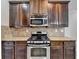 A kitchen with granite countertops and stainless steel oven and microwave at 4463 Grove Lake St, Loganville, GA 30052