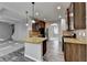 Spacious kitchen with center island, granite counters, dark cabinets, and wood floors at 4463 Grove Lake St, Loganville, GA 30052