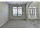 Cozy living room with neutral gray walls, new carpet and a view to the foyer at 4463 Grove Lake St, Loganville, GA 30052