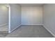 Carpeted living area showcasing neutral color palette and arched entrance at 4463 Grove Lake St, Loganville, GA 30052