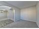 Carpeted living area showcasing neutral color palette and arched entrance to foyer and dining room at 4463 Grove Lake St, Loganville, GA 30052