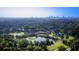 Aerial view of the golf course, pond, tennis court, clubhouse and Atlanta skyline in the distance at 80 La Rue Nw Pl, Atlanta, GA 30327