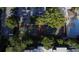 Aerial view of tennis courts and a parking lot, nestled among trees at 80 La Rue Nw Pl, Atlanta, GA 30327