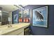 Well-lit blue bathroom with a vanity, framed pictures and stainless steel fixtures at 80 La Rue Nw Pl, Atlanta, GA 30327