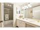 Bright bathroom with a shower-tub, white vanity, mirrored wall and soft neutral tones at 80 La Rue Nw Pl, Atlanta, GA 30327