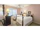 Comfortable bedroom featuring two twin beds, a large window with seating and warm pink walls at 80 La Rue Nw Pl, Atlanta, GA 30327