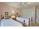 Charming bedroom with pink walls, ceiling fan and coordinated twin beds, each with lamps at 80 La Rue Nw Pl, Atlanta, GA 30327