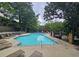 Relaxing community pool and lounge chairs nestled among mature trees and community at 80 La Rue Nw Pl, Atlanta, GA 30327