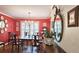 Formal dining room with red walls, shutters, chandelier, hardwood floors and elegant decor at 80 La Rue Nw Pl, Atlanta, GA 30327