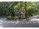 Gated guardhouse entry with well-maintained landscaping and mature trees at 80 La Rue Nw Pl, Atlanta, GA 30327