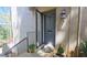Inviting front entrance with a stylish gray door and security screen, framed by blooming plants at 80 La Rue Nw Pl, Atlanta, GA 30327