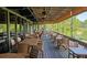 Spacious outdoor dining area with ceiling fans overlooking landscaped community at 80 La Rue Nw Pl, Atlanta, GA 30327