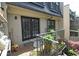 Outdoor patio featuring black framed doors, brick flooring, and a metal fence with a lovely view of the landscape at 80 La Rue Nw Pl, Atlanta, GA 30327