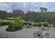 Beautiful patio seating overlooks a serene lake surrounded by lush greenery and flowering trees at 80 La Rue Nw Pl, Atlanta, GA 30327
