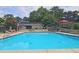 Community swimming pool surrounded by lounge chairs and well-maintained landscaping at 80 La Rue Nw Pl, Atlanta, GA 30327