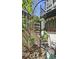 View of the garden's spiral staircase, surrounded by trees and climbing plants at 80 La Rue Nw Pl, Atlanta, GA 30327