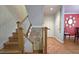 View of the staircase with wood steps, white banisters, and artwork along the wall at 80 La Rue Nw Pl, Atlanta, GA 30327
