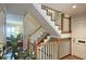 Elegant staircase with wooden banister, white rails, and trim, leading to the upper level of the home at 80 La Rue Nw Pl, Atlanta, GA 30327