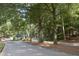 Scenic street view showcases lush landscaping and mature trees in a peaceful neighborhood at 80 La Rue Nw Pl, Atlanta, GA 30327