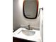 Bathroom vanity with modern vessel sink and decorative wood mirror at 1864 Drew Cir, Austell, GA 30168