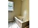A soaking tub with a window letting in natural light at 1864 Drew Cir, Austell, GA 30168