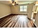 Bright bedroom with a ceiling fan, and wood-look flooring next to a bathroom at 1864 Drew Cir, Austell, GA 30168