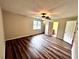 Spacious bedroom with ceiling fan, light walls, and wood-look floors at 1864 Drew Cir, Austell, GA 30168