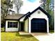 Charming single-story home with painted brick, black trim, and attached garage at 1864 Drew Cir, Austell, GA 30168