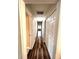 Hallway with hardwood floors and doors on either side at 1864 Drew Cir, Austell, GA 30168