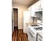 Well-organized kitchen featuring white appliances, granite countertops, and ample storage space at 1864 Drew Cir, Austell, GA 30168