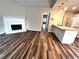 Open-concept living room connects seamlessly with the kitchen, showcasing wood floors and a fireplace at 1864 Drew Cir, Austell, GA 30168