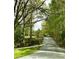 A view down a street with lush trees on each side of the road at 1864 Drew Cir, Austell, GA 30168