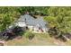 Overhead view of a home surrounded by lush greenery, a long driveway, and mature trees at 4340 Hadaway Nw Rd, Kennesaw, GA 30152