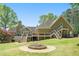 Expansive backyard with a stone fire pit, multi-level deck, and a well-maintained lawn at 4340 Hadaway Nw Rd, Kennesaw, GA 30152