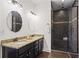 Bathroom featuring double sinks, granite countertops, and a tiled shower enclosure at 4340 Hadaway Nw Rd, Kennesaw, GA 30152