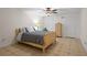 Cozy bedroom featuring tile flooring, a ceiling fan, and a wooden bed frame, offering a relaxing space at 4340 Hadaway Nw Rd, Kennesaw, GA 30152