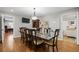 Formal dining room featuring a large table with seating for eight, hardwood floors, and modern lighting at 4340 Hadaway Nw Rd, Kennesaw, GA 30152