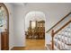Elegant entry foyer with staircase and view of the dining room through an arched doorway at 4340 Hadaway Nw Rd, Kennesaw, GA 30152