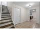 Inviting hallway with tile flooring leads to a living space, complemented by a staircase to the upper level at 4340 Hadaway Nw Rd, Kennesaw, GA 30152