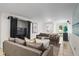 Comfortable living room featuring plush sofas, modern decor, and natural light streaming in through the nearby door at 4340 Hadaway Nw Rd, Kennesaw, GA 30152