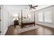 Spacious main bedroom with a four-poster bed, ceiling fan, and abundant natural light from the windows at 4340 Hadaway Nw Rd, Kennesaw, GA 30152