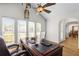 Well-lit office space featuring a large wooden desk, ceiling fan, and plenty of natural light at 4340 Hadaway Nw Rd, Kennesaw, GA 30152