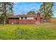 Spacious backyard featuring a lush green lawn and mature trees, perfect for outdoor activities at 1150 Tinsley Nw Dr, Conyers, GA 30012