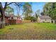 View of backyard with home and detached garage at 1150 Tinsley Nw Dr, Conyers, GA 30012