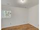 Unfinished bedroom featuring a large window and wood flooring at 1150 Tinsley Nw Dr, Conyers, GA 30012