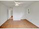 Neutral bedroom featuring wood-look floors, white walls, and a view into the hallway at 1150 Tinsley Nw Dr, Conyers, GA 30012