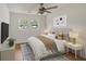 Comfortable bedroom with natural light, ceiling fan, and modern decor for a relaxing atmosphere at 1150 Tinsley Nw Dr, Conyers, GA 30012