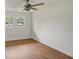 A neutral bedroom showing hard surface floors, bright white paint, and a ceiling fan at 1150 Tinsley Nw Dr, Conyers, GA 30012
