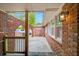 Covered walkway with stone floor leading to the red brick courtyard with arched entryways at 1150 Tinsley Nw Dr, Conyers, GA 30012