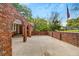 Unique red brick courtyard featuring arched entryways and a spacious concrete patio at 1150 Tinsley Nw Dr, Conyers, GA 30012
